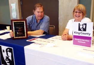 Mark Hoge and Paula Wilz at the King County table with the U.S. Communities award